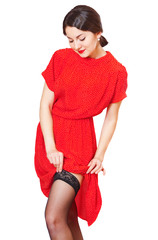Lovely girl in red dress straightens stockings