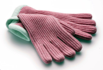 pink woolen gloves on white