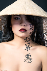 Beautiful brunette Asian woman with long black hair wears vietna