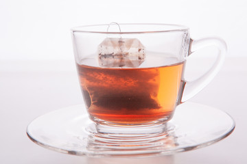 Black tea in glass cup. Isolated on white background