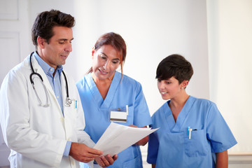 Professional medical team looking at documents