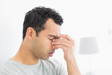 Close-up side view of a thoughtful man in bed