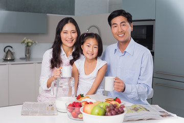 Happy young girl enjoying breakfast with parents