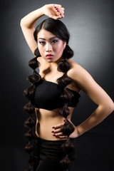 Naklejka premium Beautiful brunette Asian woman with long black hair