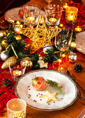 Christmas eve dinner party table setting with decorations