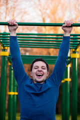 Fototapeta premium Athlete doing pull-ups on bar