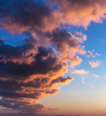 Dramatic sunrise with gold colored clouds.