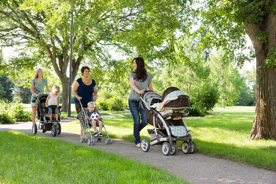 Mothers With Baby Carriages Walking In Park