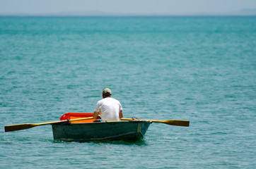 Man row dinghy - Powered by Adobe