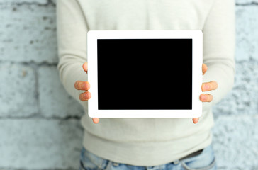 Closeup image of male hands showing display of tablet computer 