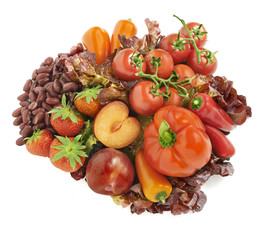 all kinds of red fruits and vegetables arranged in a group with
