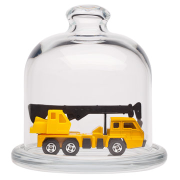 Toy truck crane in a glass dome.
