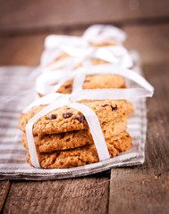 Stacked chocolate chip cookies on wooden table