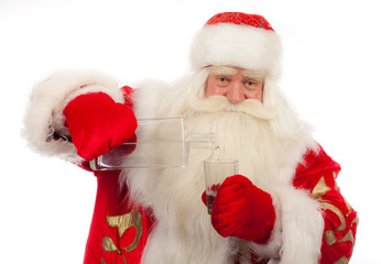 Fototapeta premium Santa Claus is pouring vodka into the glass.