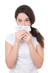 young brunette woman showing blister of pills isolated on white