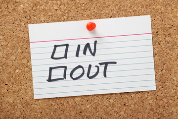 In or Out Tick Boxes on a cork board