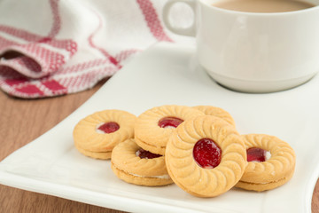 Strawberry jam sandwich biscuits with coffee cup