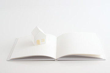 House of paper and white book