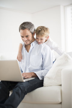 father and son playing on a computer