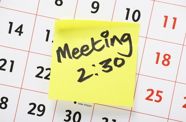 Meeting Reminder Sticker on a Wall Calender