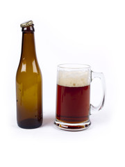 Empty bottle of bock beer next to a full glass