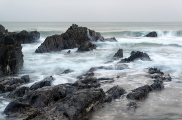 Landscape seascape of jagged and rugged rocks on coastline with