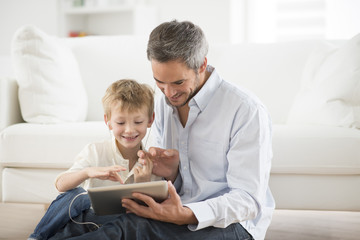 father and son sharing music headphones