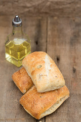 Olive bread rollis in rustic kitchen setting with utensils