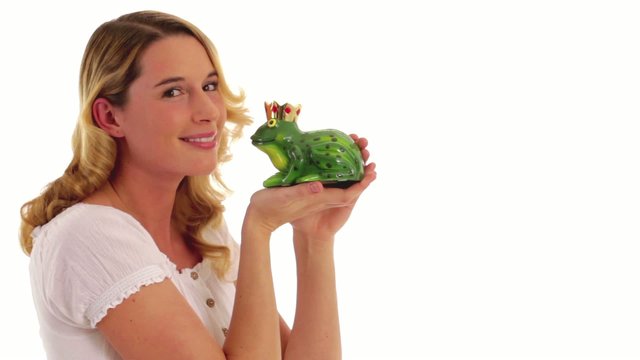young woman kisses a frog