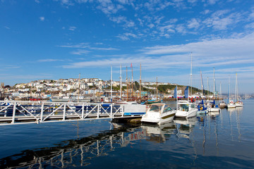 Fototapeta na wymiar Jetty and boats and yachts on calm blue sea with cloud