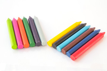 olored wax crayons isolated on white background.