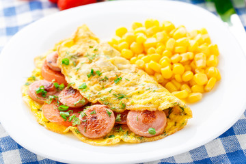 Omelet with sausage, tomato and herbs