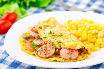 Omelet with sausage, tomato and herbs