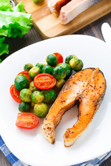 Salmon with roasted brussels sprout and tomato