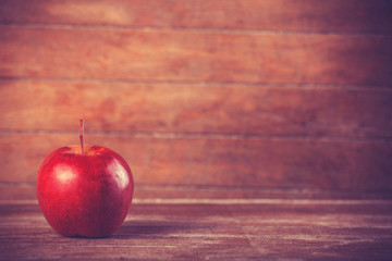 red apple on wooden table