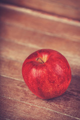 red apple on wooden table