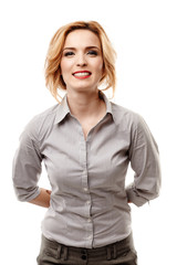 Confident businesswoman with hands at back smiling