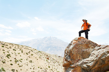 Tourist hiker hands up on mountain top