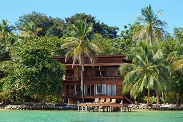 Gordijnen Tropical waterfront beach house © dam