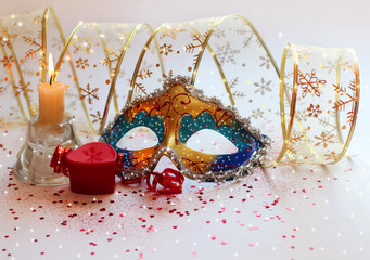 Christmas composition with a mask, gifts and candles