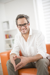 Obraz premium attractive man smiling on a couch