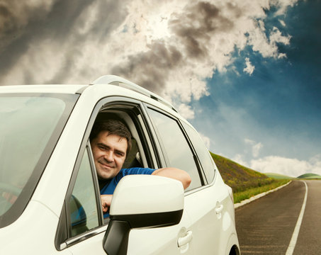 Man driving his car on the lonely road