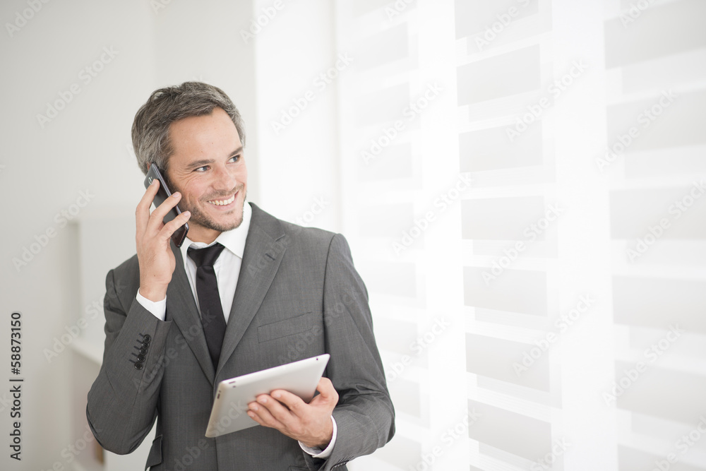 Wall mural young businessman surfing on tablet