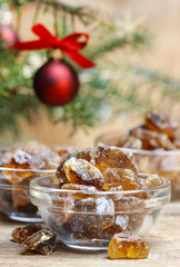 Granulated brown sugar in transparent glass bowl on wooden table