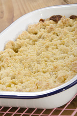 warm baked apple crumble in an enamel bowl