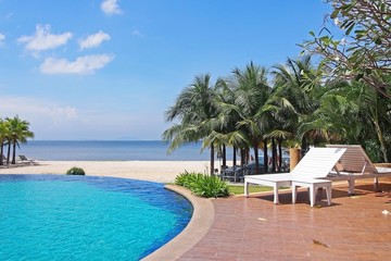 Fototapeta na wymiar White beach chair beside swimming pool ,Thailand