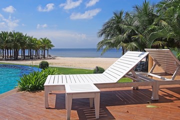 White beach chair beside swimming pool  ,Thailand