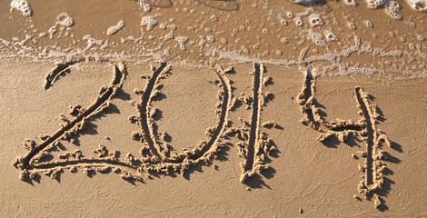 Inscription 2014 on a sandy beach