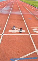 Sports shoes on running track rubber standard red color