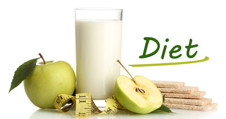 Glass of yogurt, green apples, crispbreads and measuring tape